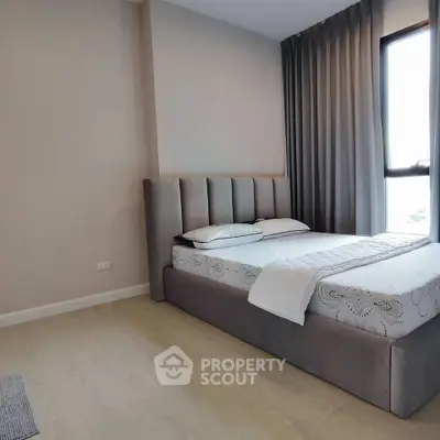 Modern bedroom with stylish bed and floor-to-ceiling curtains in a cozy apartment.