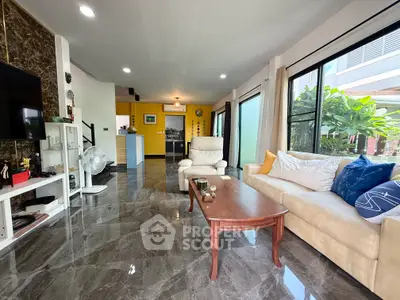 Spacious modern living room with marble floors and large windows offering garden views.