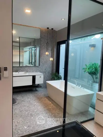 Luxurious modern bathroom with freestanding bathtub and elegant lighting