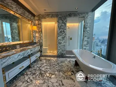 Luxurious marble bathroom with freestanding bathtub and city view