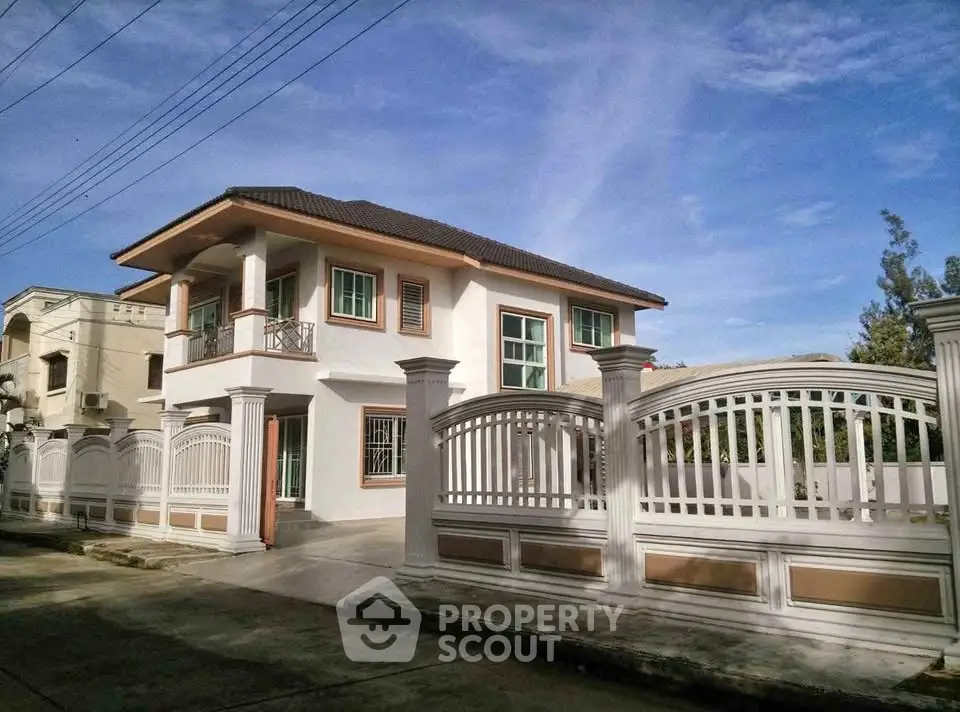 Elegant two-story house with gated entrance and modern design in a serene neighborhood.