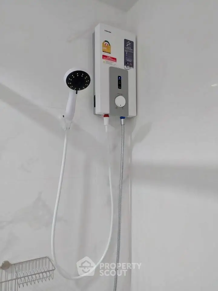 Modern bathroom with sleek water heater and shower setup