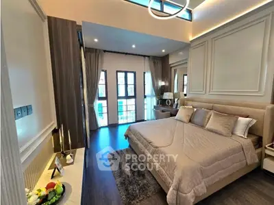 Luxurious modern bedroom with elegant decor and large windows for natural light.
