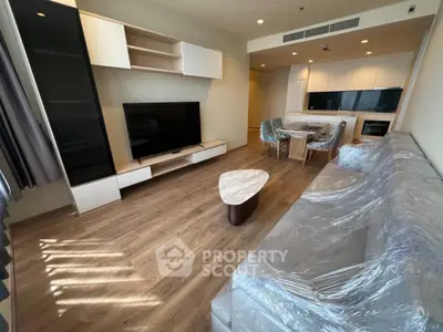 Modern living room with sleek furniture and open kitchen layout