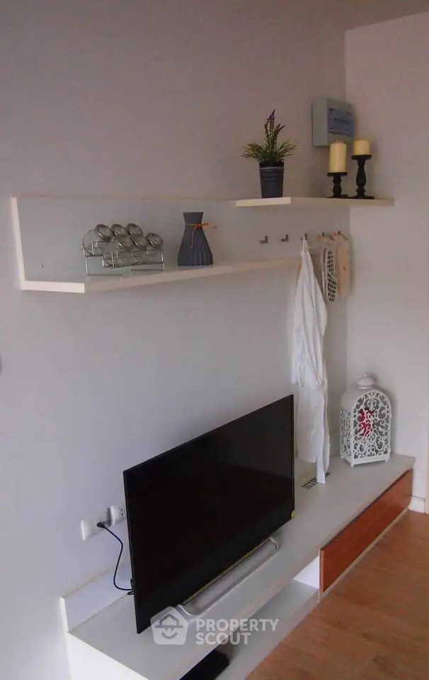 Modern living room with sleek TV setup and stylish shelving