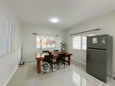 Spacious dining area with modern fridge and elegant wooden table