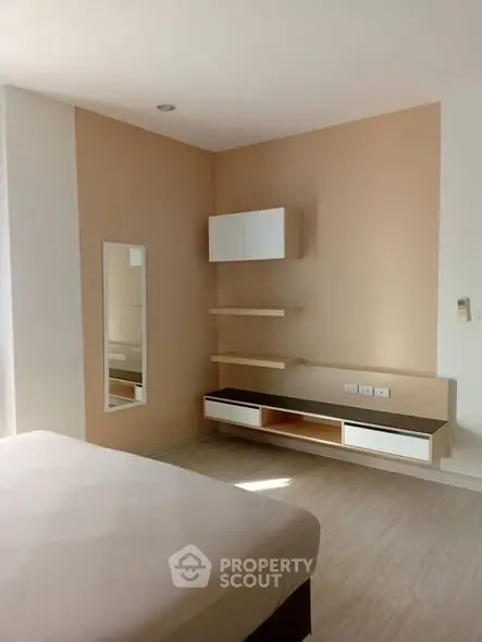 Modern minimalist bedroom with sleek storage and neutral tones