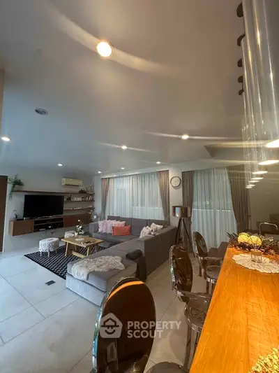 Spacious modern living room with stylish decor and ample natural light