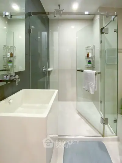Modern bathroom interior with glass shower enclosure, sleek bathtub, and elegant finishes, perfect for a luxurious urban living experience.