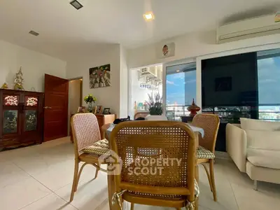 Charming living room with elegant decor and city view from balcony.