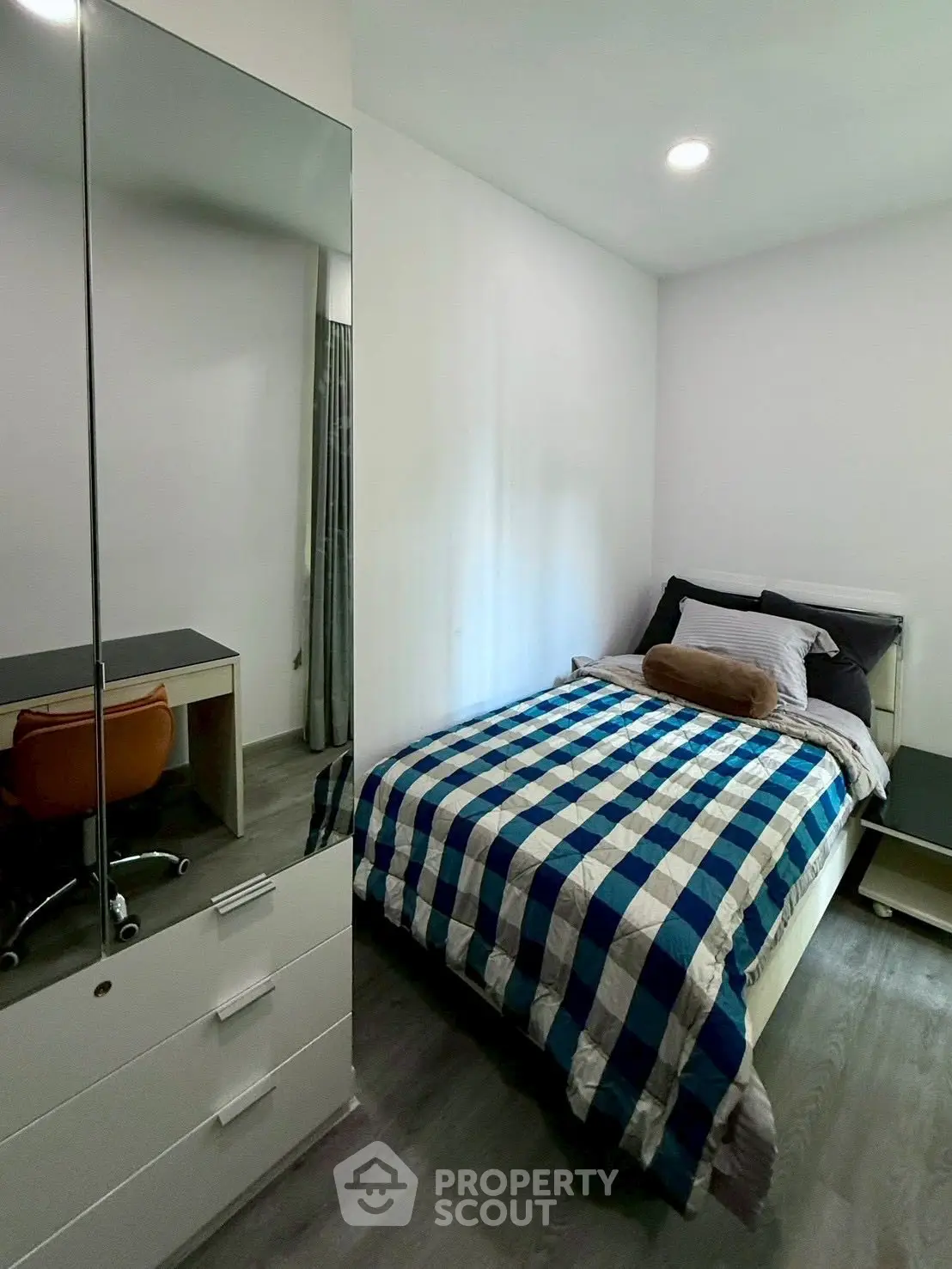 Cozy bedroom with modern decor and ample storage space