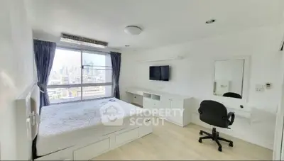 Spacious bedroom with city view, modern furnishings, and ample natural light.