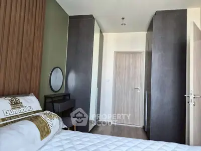 Modern bedroom with stylish decor and ample storage space in a contemporary apartment.