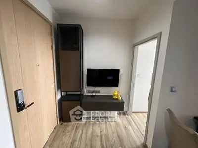 Modern apartment interior with TV and wooden flooring