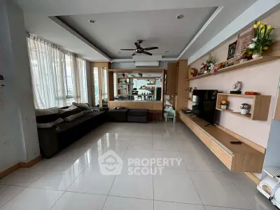 Spacious modern living room with sleek furniture and large windows for natural light.