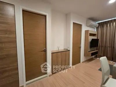 Modern living room with wooden doors and sleek furniture in a stylish apartment.