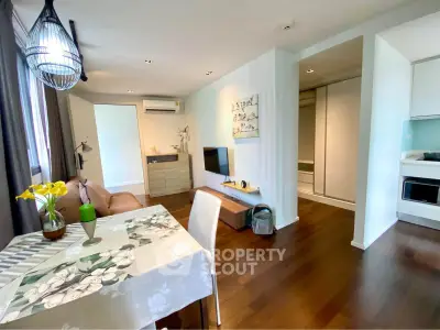 Modern living room with dining area and stylish decor in a cozy apartment.
