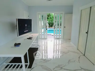 Modern living room with sleek design and pool view through French doors.