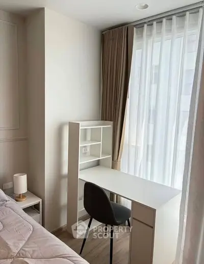 Cozy bedroom corner with study desk and natural light, perfect for productivity and relaxation.