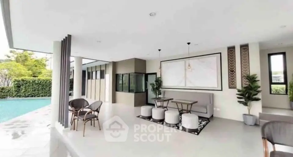 Luxurious outdoor living area with modern furniture and pool view, perfect for relaxation and entertainment.