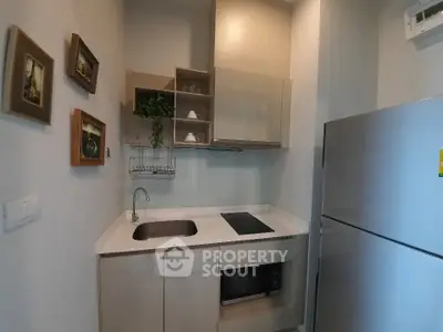 Modern compact kitchen with sleek appliances and stylish decor