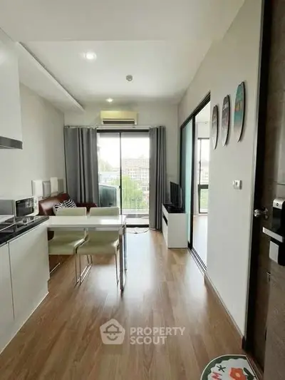 Modern apartment living room with open kitchen and balcony view