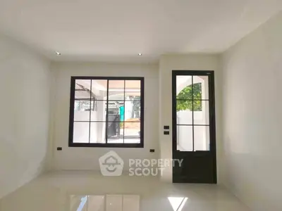 Bright and modern living room with large window and sleek door design