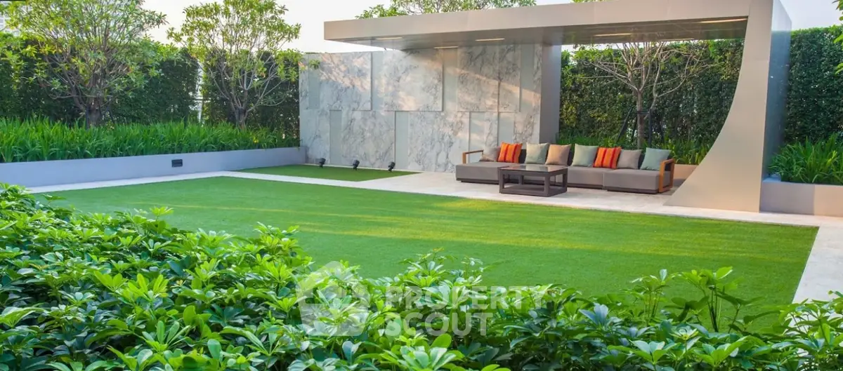 Luxurious garden with modern seating area and lush greenery