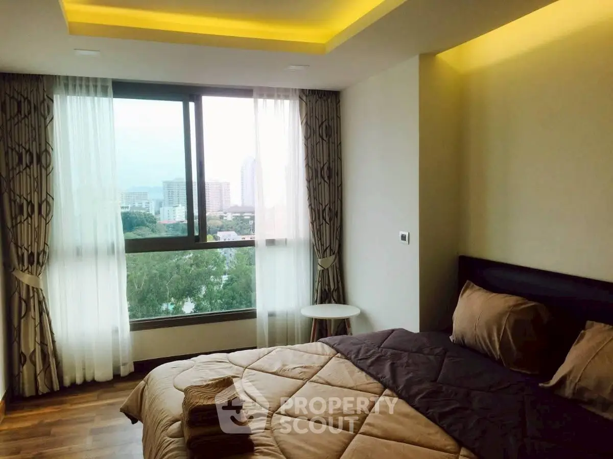 Cozy bedroom with city view, modern decor, and natural light.