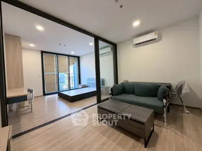 Modern living room with sleek design and large windows in a stylish apartment.