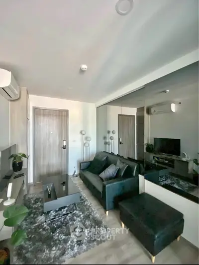 Modern living room with sleek design, featuring a cozy sofa and stylish decor.