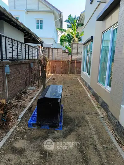 Narrow side yard between modern houses with landscaping potential