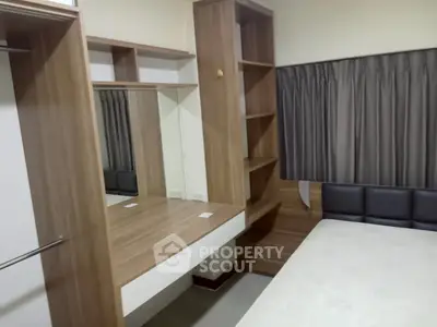 Modern bedroom with wooden furniture and built-in shelves