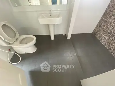 Modern bathroom with sleek design and tiled flooring