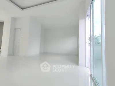 Spacious modern interior with large windows and sleek white flooring