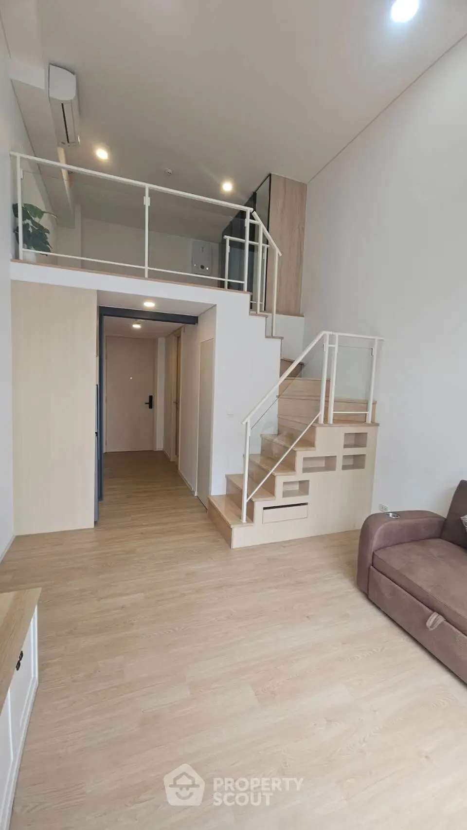Modern loft apartment with mezzanine and stylish wooden flooring