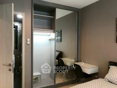 Modern bedroom with mirrored wardrobe and sleek furniture design