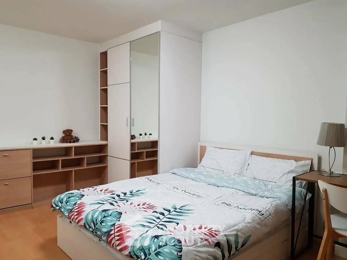 Spacious bedroom with modern furniture and vibrant bedding