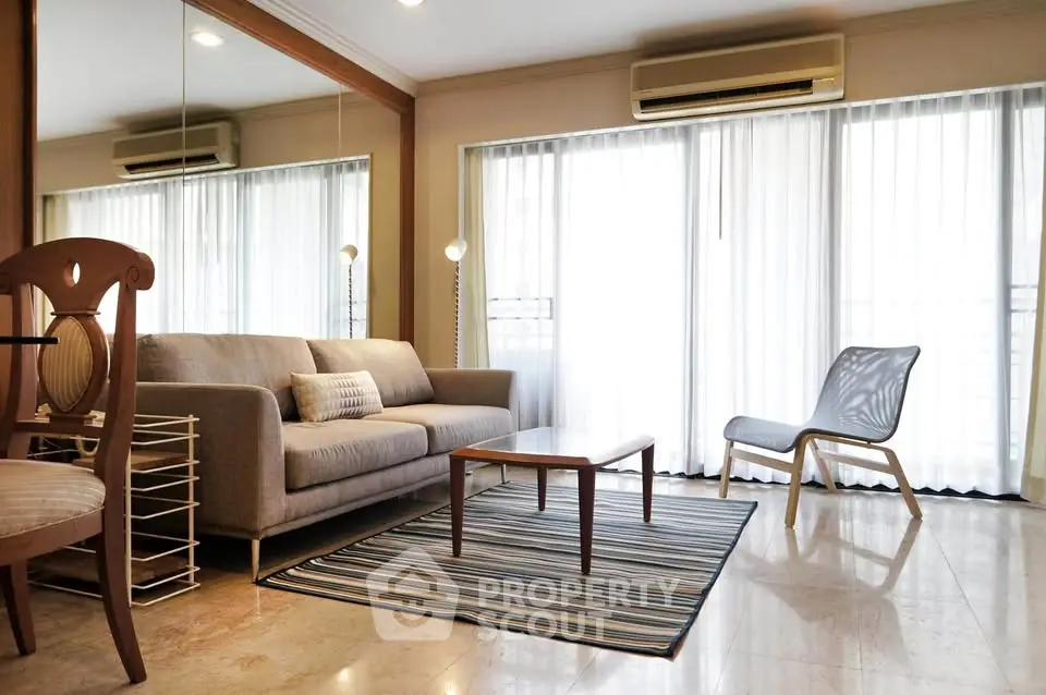 Spacious living room with modern furniture and large windows for natural light