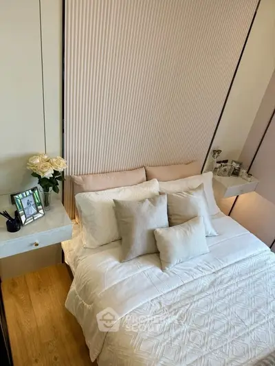 Elegant bedroom with cozy bedding and stylish decor, perfect for relaxation and comfort.