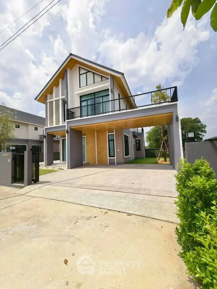 Modern two-story house with spacious balcony and sleek exterior design.