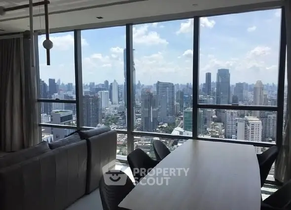 Luxurious high-rise apartment with stunning city skyline view from the living room.