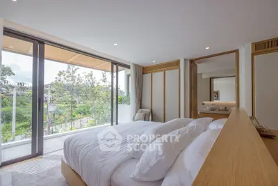 Luxurious bedroom with large windows and scenic view, featuring modern decor and ample natural light.