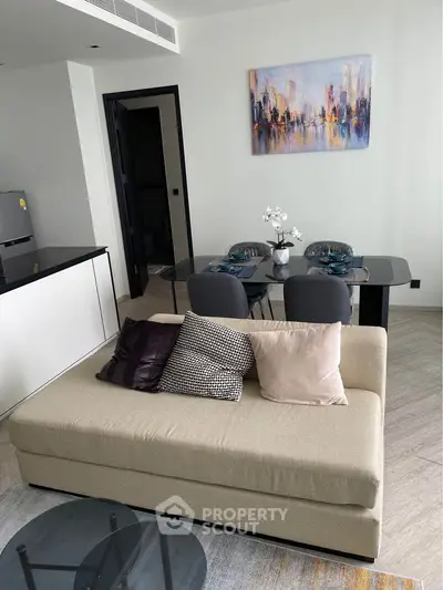 Modern living room with stylish sofa and dining area in open layout apartment.