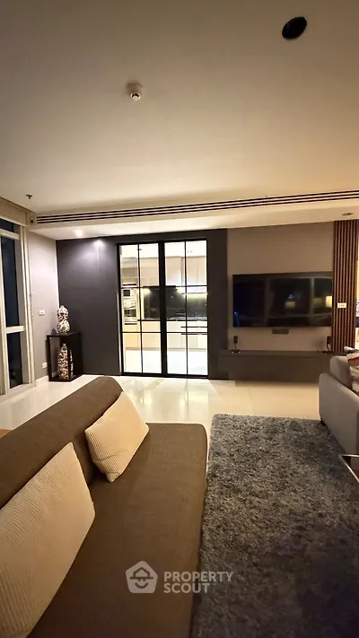 Spacious modern living room with sleek design and large TV setup