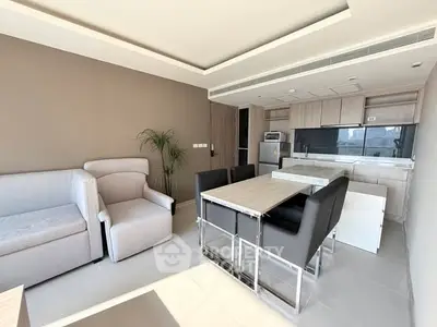 Modern living room with open kitchen and stylish furniture in a bright apartment.
