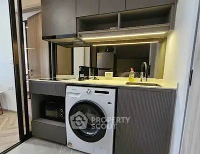 Modern compact kitchen with washing machine and sleek cabinetry