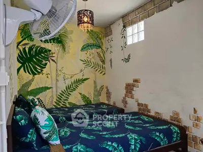 Tropical-themed bedroom with twin beds and leafy decor, perfect for a serene retreat.