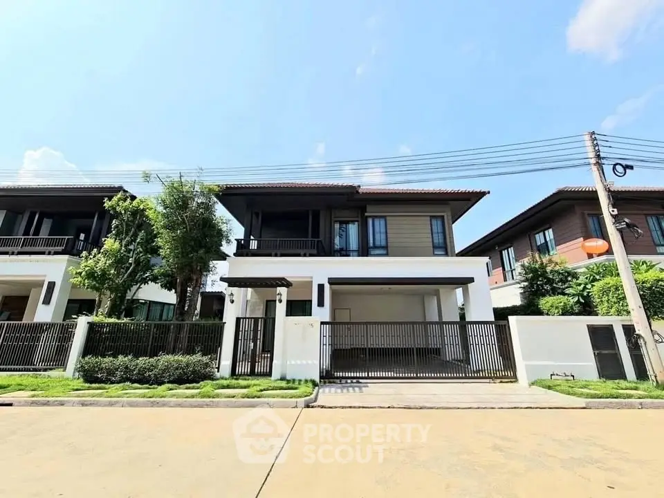 Modern two-story house with sleek design and spacious driveway in a serene neighborhood.