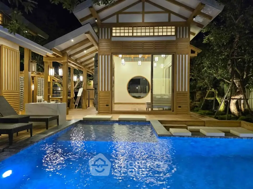 Stunning modern home with illuminated pool and elegant wooden architecture